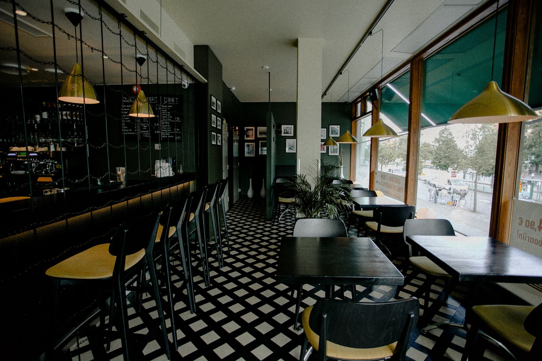 Modern cafe interior design with empty seating and unique lighting.